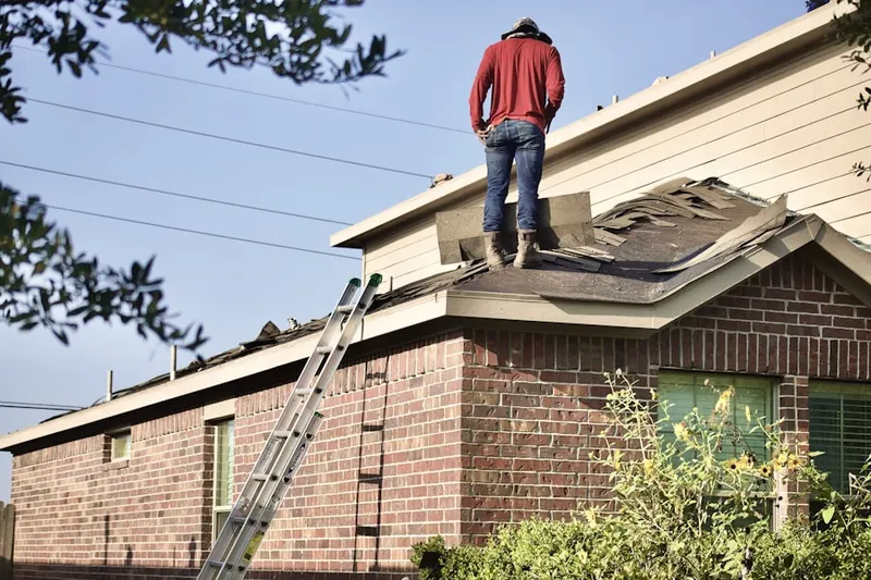 Professional roofer working on a residential roof in Red Hawk